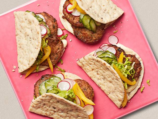 Pitas with patties and vegetables.