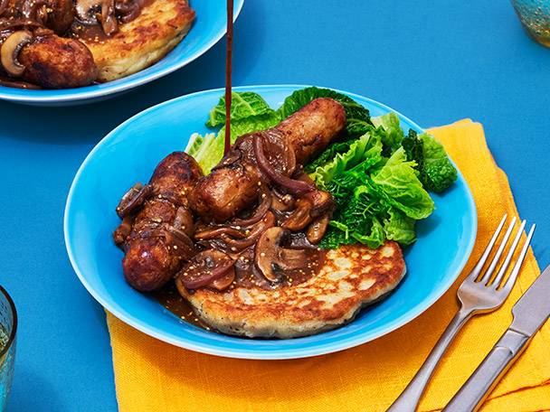 Sausages, mash, and mushrooms in gravy.