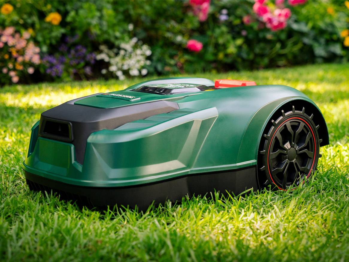 Green Gardena robotic lawnmower on grass.