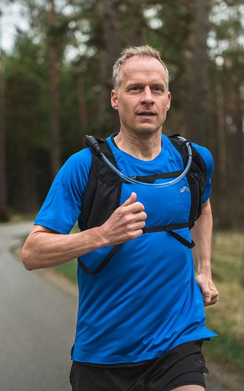 Man running with Salomon hydration vest.