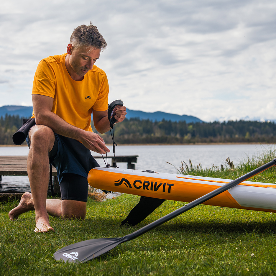 Crivit paddleboard and paddle, preparing for watersports.