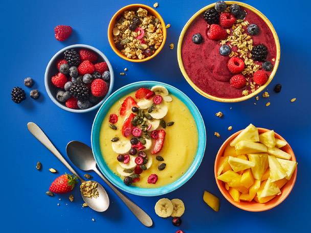 Fruit smoothies with berries and mango, granola.