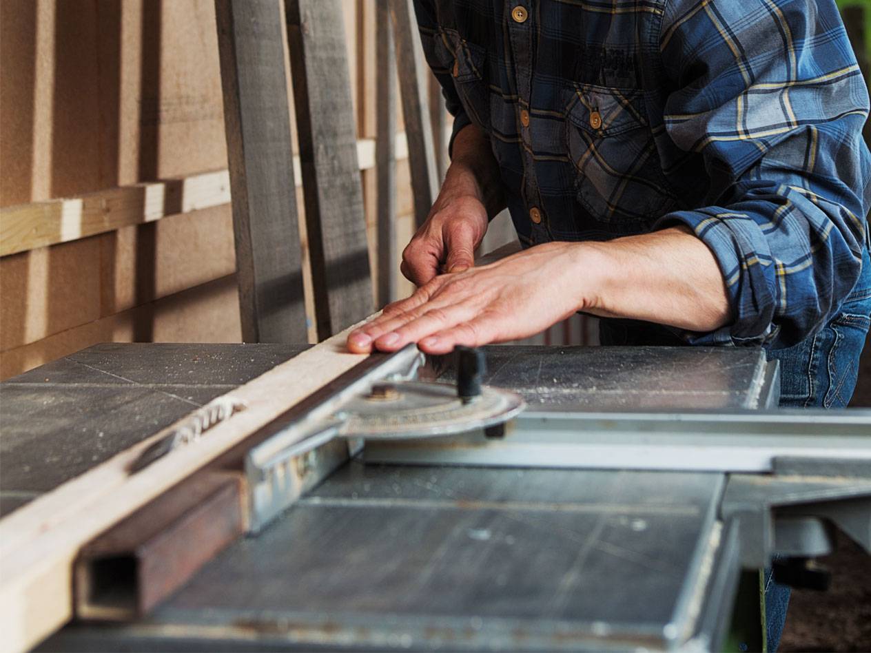 Woodworking with a table saw.