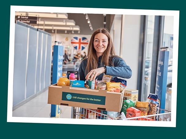 Woman with a Lidl shopping cart full of groceries.