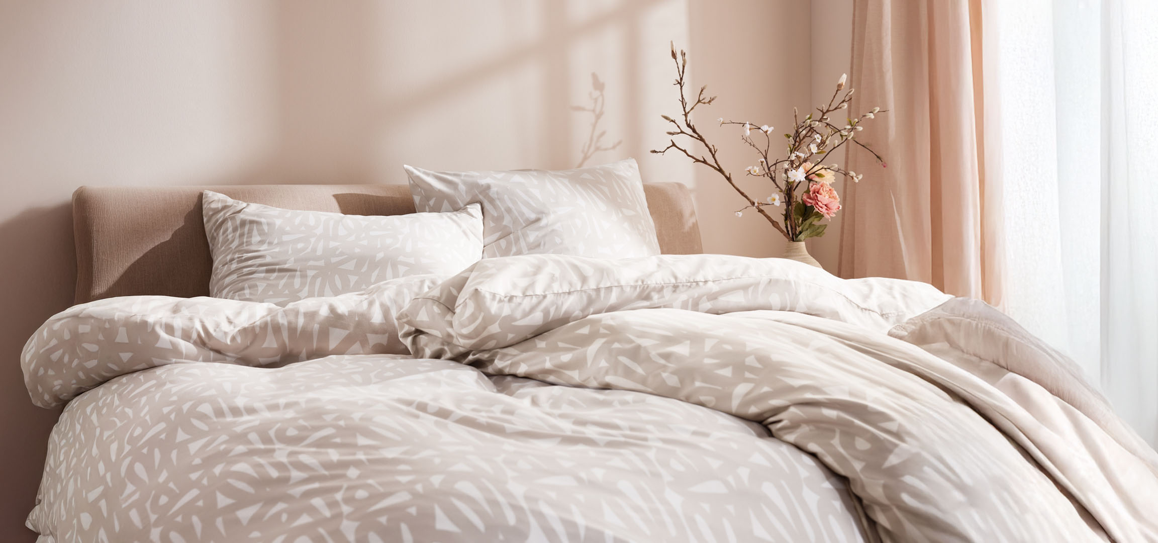 Beige bedding with abstract patterns.