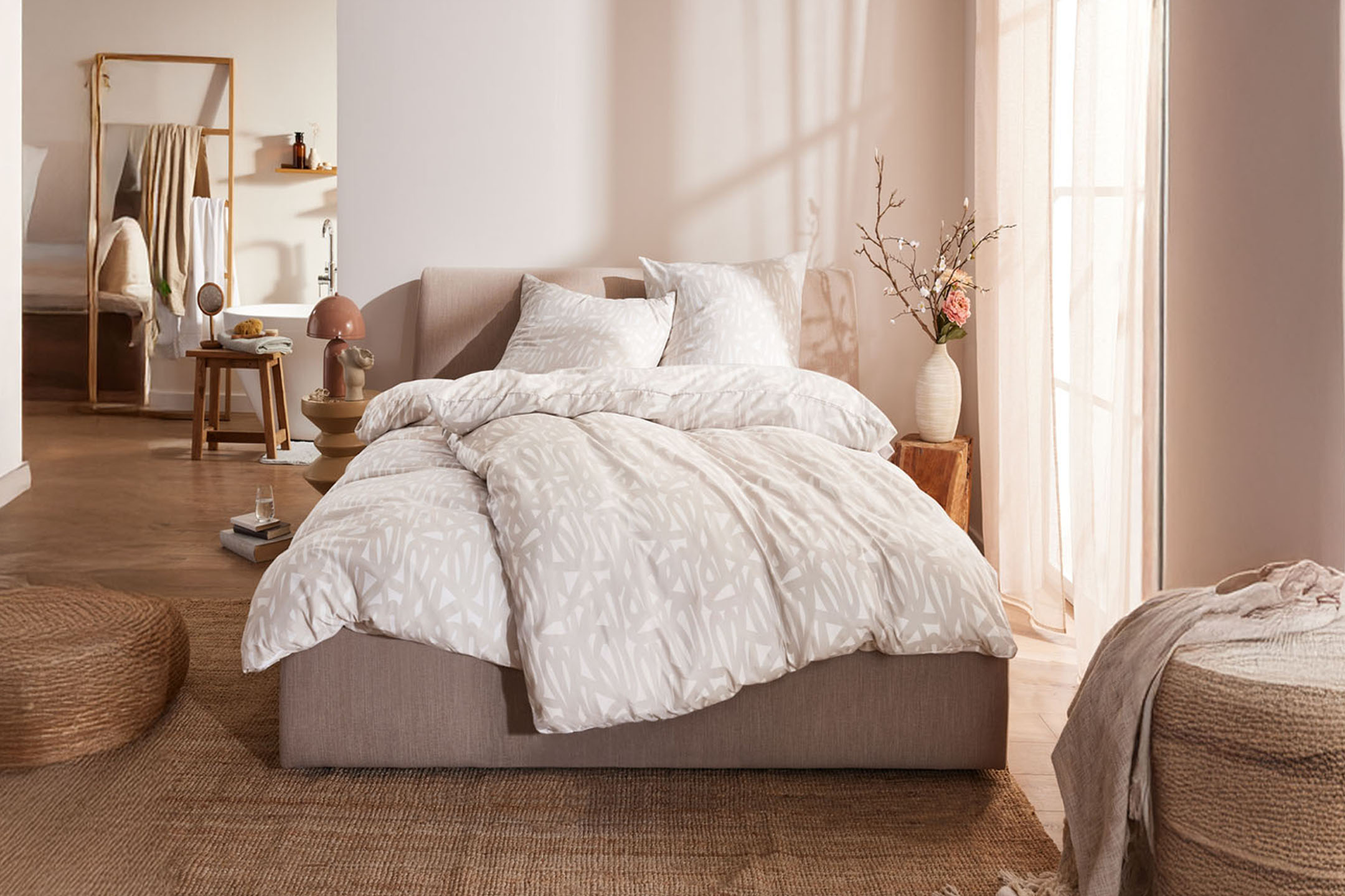 Modern bedding and home decor in a neutral palette.